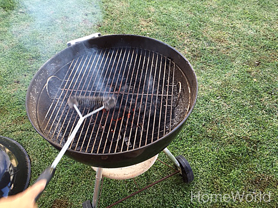 Now that the grate is hot, use a long handle wire brush (the longer, the better) to clean the the grate.