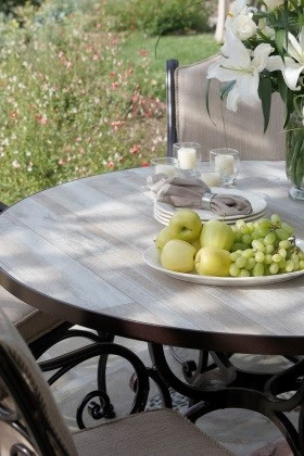 Photo caption: This reclaimed-wood-look table is actually durable porcelain tile. Photo credit: OW Lee